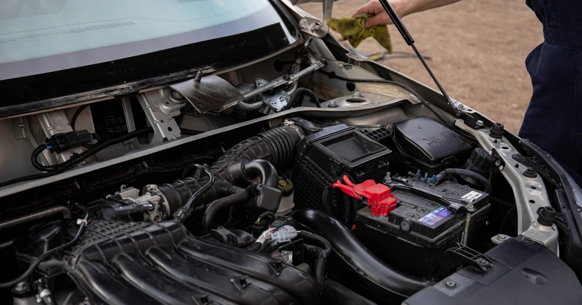 Car battery replacement at home in Lahore - a mechanic fitting a new battery